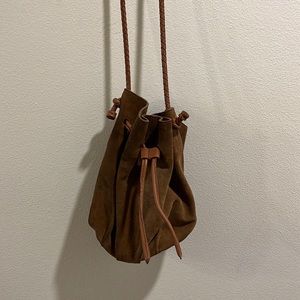 Suede boho satchel bag with woven strap.